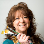 Photo of me holding paintbrushes